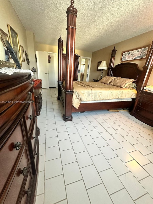 tiled bedroom featuring a textured ceiling