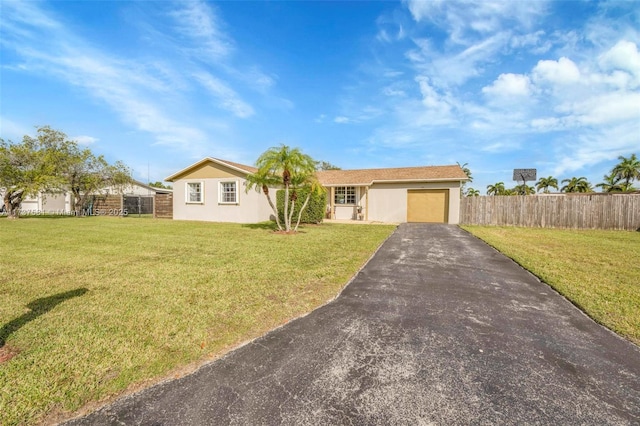 ranch-style home featuring a garage and a front yard