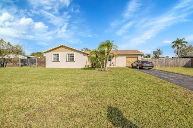 view of front of house featuring a garage and a front lawn