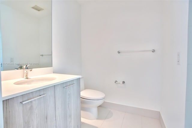 bathroom featuring vanity, tile patterned floors, and toilet