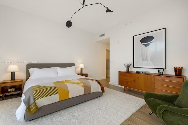 bedroom with wood-type flooring