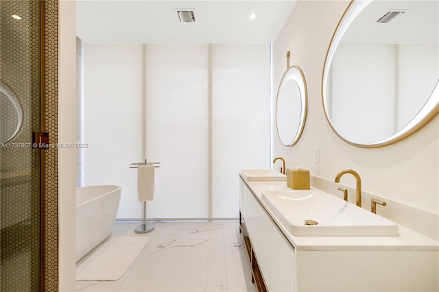 bathroom featuring a washtub and vanity