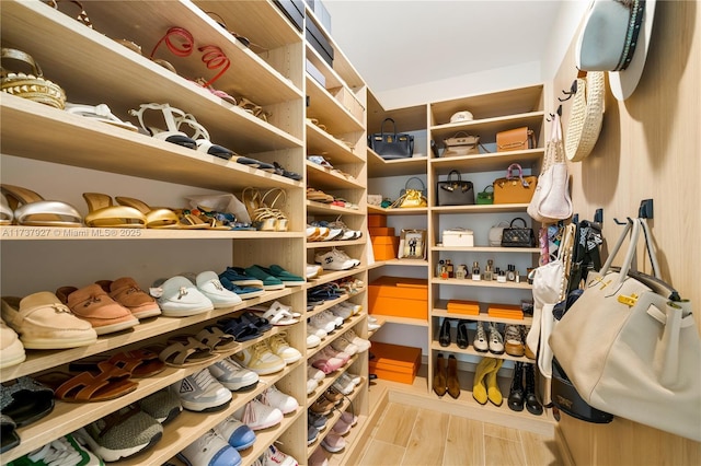 spacious closet featuring light hardwood / wood-style floors