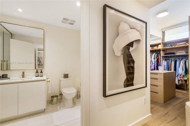 bathroom featuring vanity and toilet