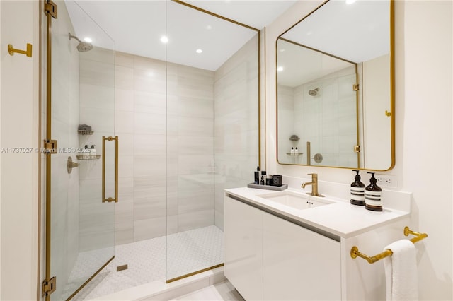 bathroom with vanity and a shower with door