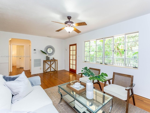 living room featuring hardwood / wood-style floors and ceiling fan