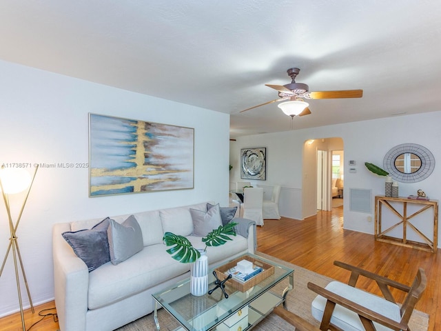 living room featuring ceiling fan and hardwood / wood-style floors