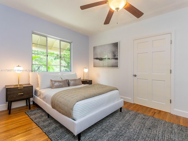 bedroom with hardwood / wood-style flooring and ceiling fan