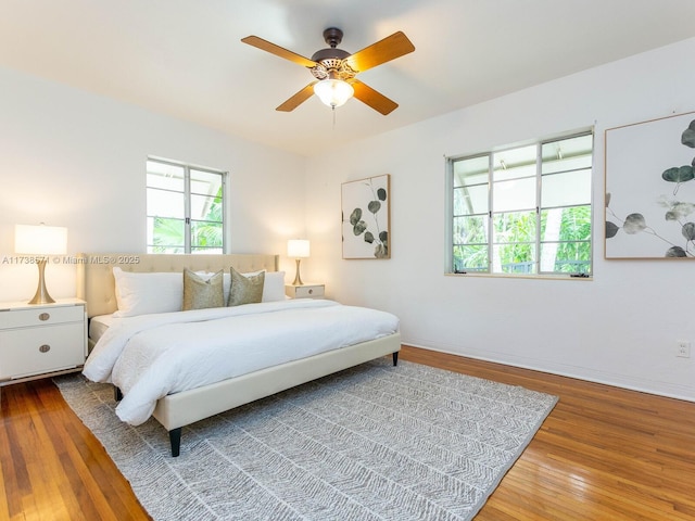 bedroom with hardwood / wood-style flooring and ceiling fan