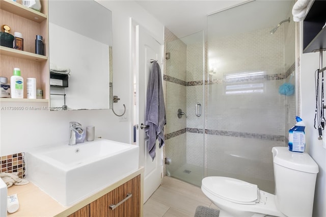 bathroom with walk in shower, vanity, toilet, and tile patterned flooring