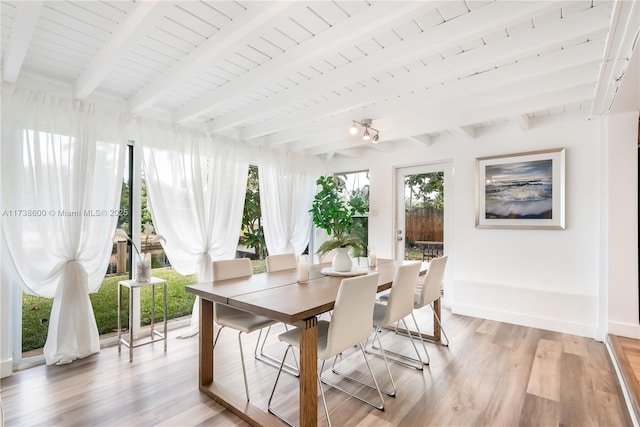 dining room with wood ceiling, beam ceiling, and light wood-type flooring