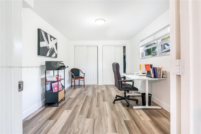 office area with light hardwood / wood-style floors