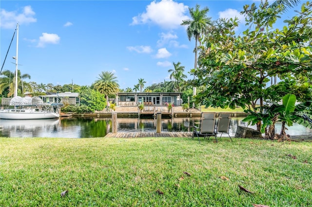 rear view of property featuring a yard and a water view