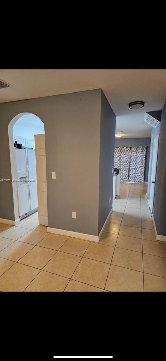 hallway featuring light tile patterned floors