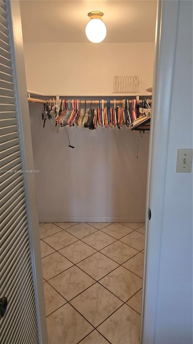 walk in closet with tile patterned flooring