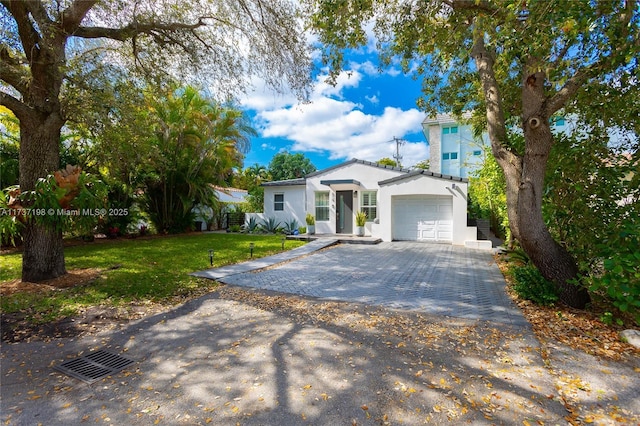 view of front of home with a garage and a front yard