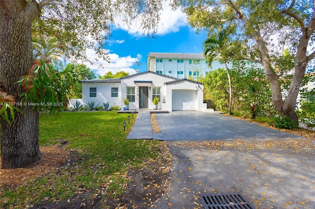 view of front of property featuring a garage and a front lawn