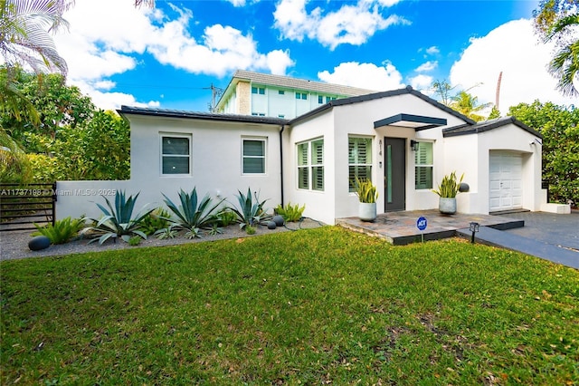 view of front of property with a garage and a front lawn