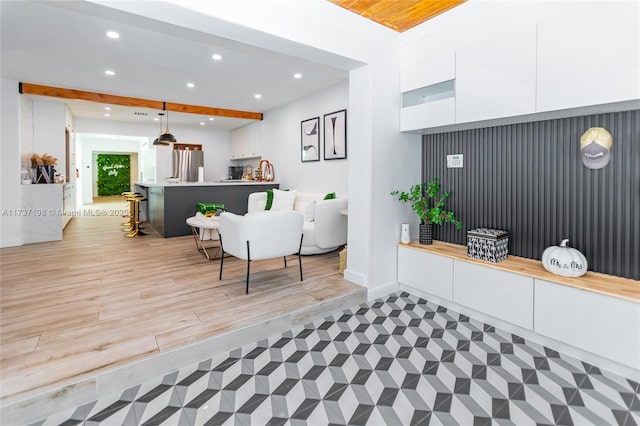 foyer entrance with beam ceiling and light hardwood / wood-style floors