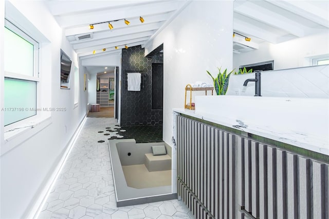 bathroom featuring tile patterned floors and lofted ceiling with beams