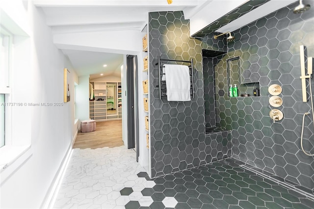 bathroom with vaulted ceiling with beams, tile patterned floors, and tiled shower