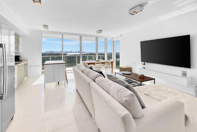 tiled living room with expansive windows and a textured ceiling