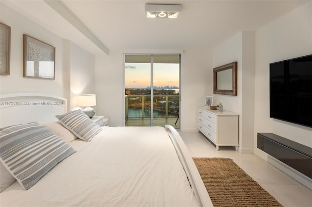 bedroom with floor to ceiling windows, access to outside, and light tile patterned floors