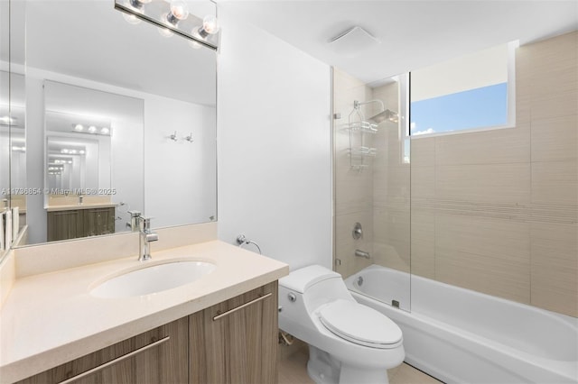 full bathroom with bath / shower combo with glass door, vanity, and toilet