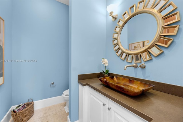 bathroom featuring vanity, tile patterned floors, and toilet