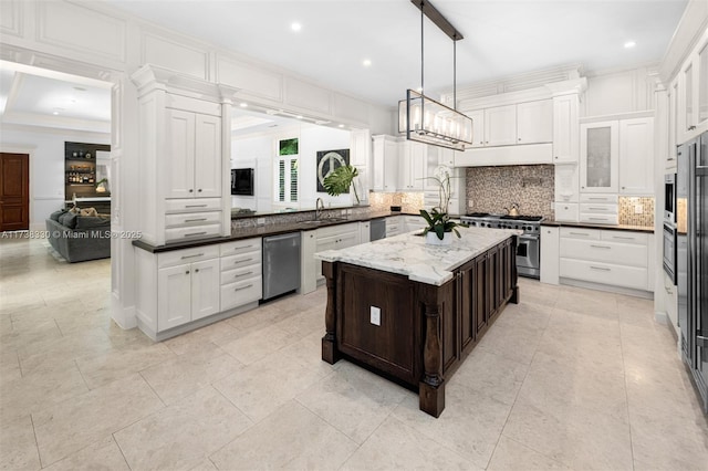 kitchen featuring dark stone counters, kitchen peninsula, a kitchen island, stainless steel appliances, and backsplash