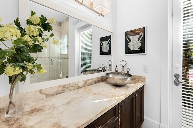 bathroom featuring vanity and an enclosed shower