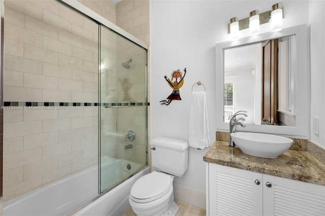 full bathroom with bath / shower combo with glass door, vanity, and toilet