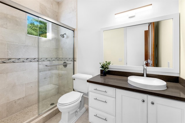 bathroom with walk in shower, vanity, and toilet