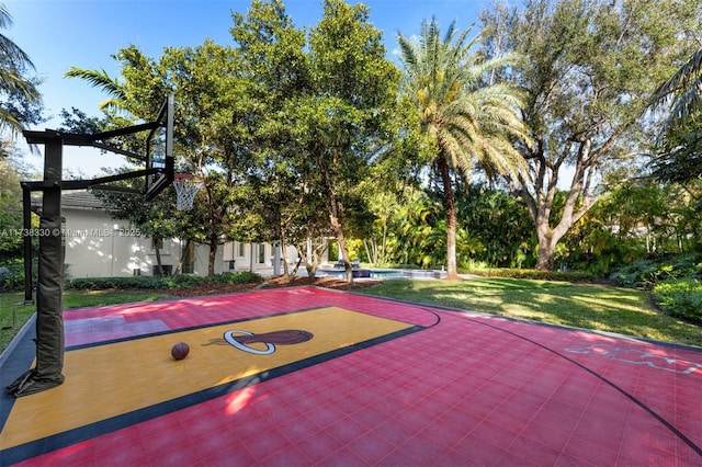 view of sport court with a yard