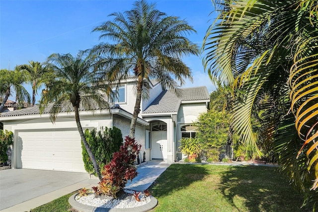 view of front of property with a garage and a front yard