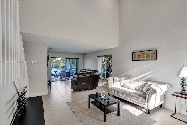 tiled living room with a towering ceiling