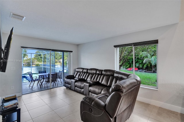 tiled living room with a water view