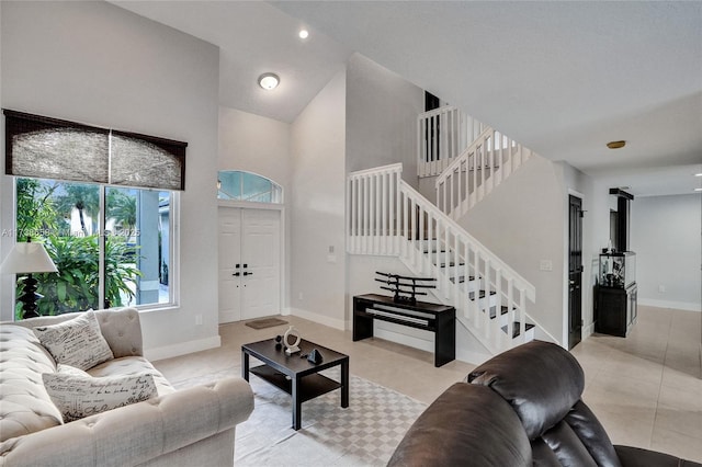 tiled living room featuring a high ceiling