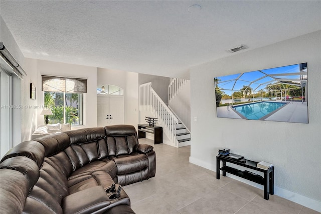 living room featuring light tile patterned floors and a textured ceiling