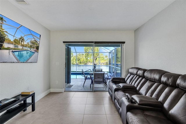 tiled living room featuring a water view