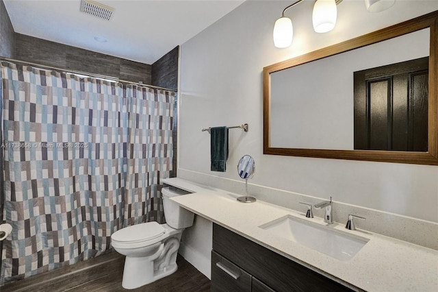 bathroom with vanity, wood-type flooring, toilet, and walk in shower