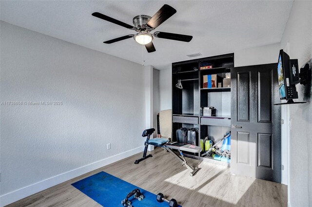 exercise room featuring hardwood / wood-style floors and ceiling fan