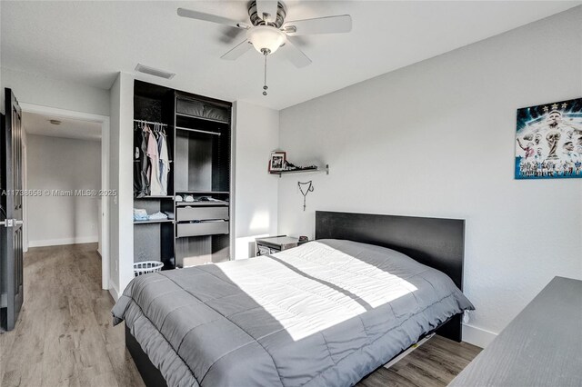 bedroom featuring ceiling fan, light hardwood / wood-style floors, and a closet