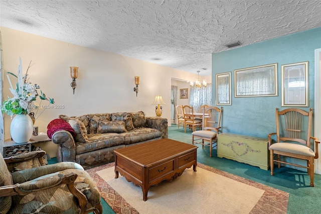 living room featuring a textured ceiling, a chandelier, and carpet flooring