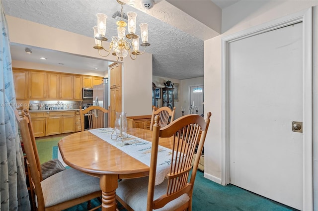 carpeted dining area with an inviting chandelier and a textured ceiling