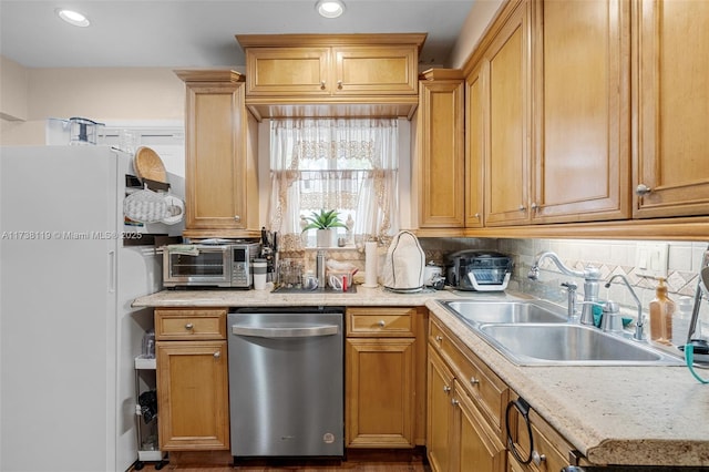 kitchen featuring sink, backsplash, dishwasher, and white refrigerator