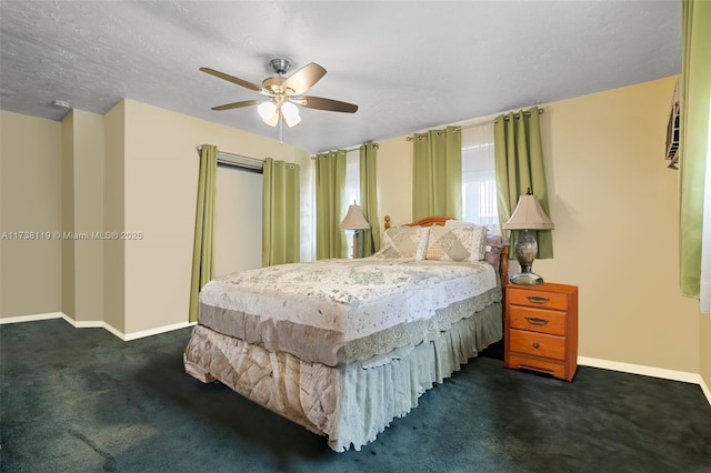 bedroom with ceiling fan, dark carpet, and a textured ceiling