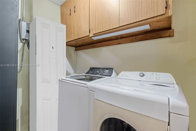 laundry room with cabinets and washer and dryer