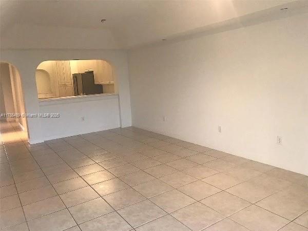 empty room with light tile patterned flooring