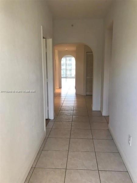 hallway with light tile patterned floors